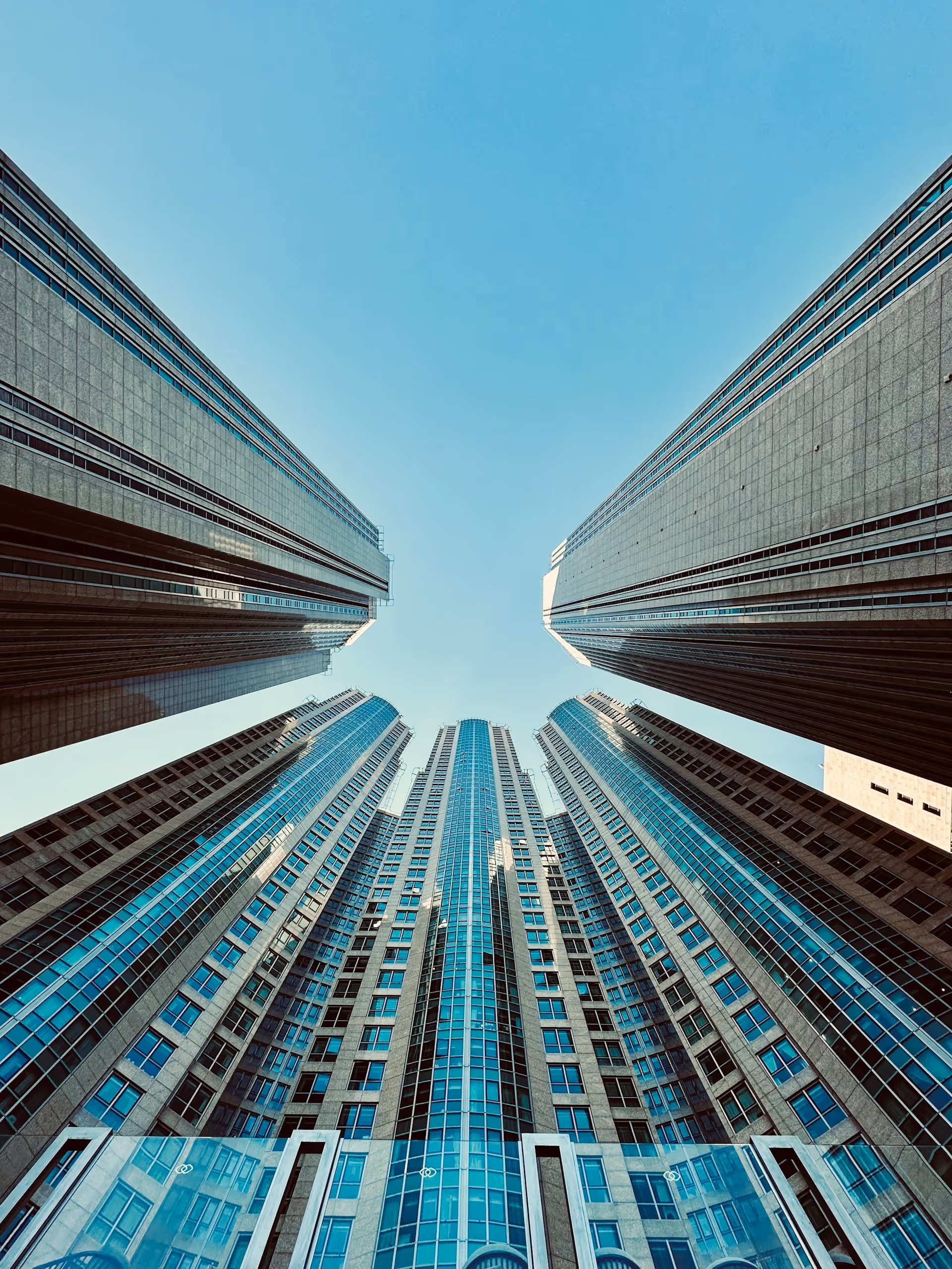 Perspective shot of Abu Dhabi skyscrapers — reflecting upward mobility and leadership transformation
